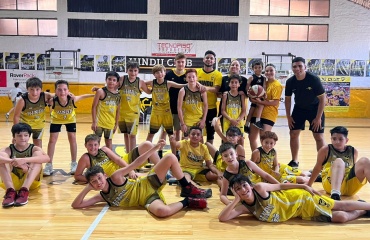 Équipe de jeunes basketteurs en tenue jaune posant dans un gymnase à Cordoba, Argentine, encadrés par des bénévoles de Globalong.